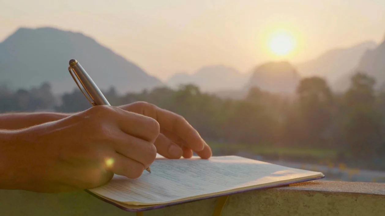 Woman writing in gratitude journal